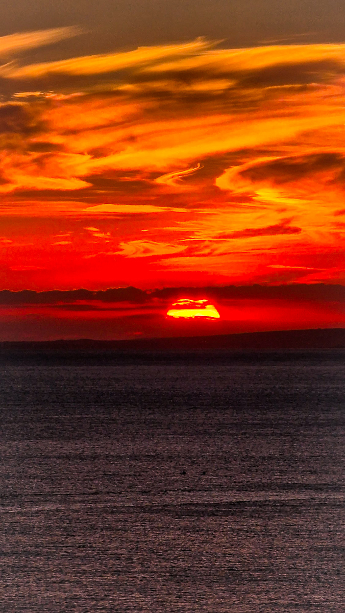 Sunset seascape photography by Tony Livins with deep orange skies